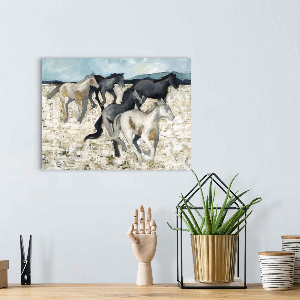 A bohemian room featuring Contemporary painting of a herd of galloping horses.
