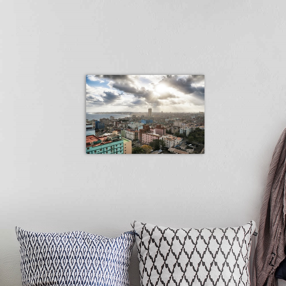 A bohemian room featuring Photograph of the sun beaming through the clouds of the city of Havana.