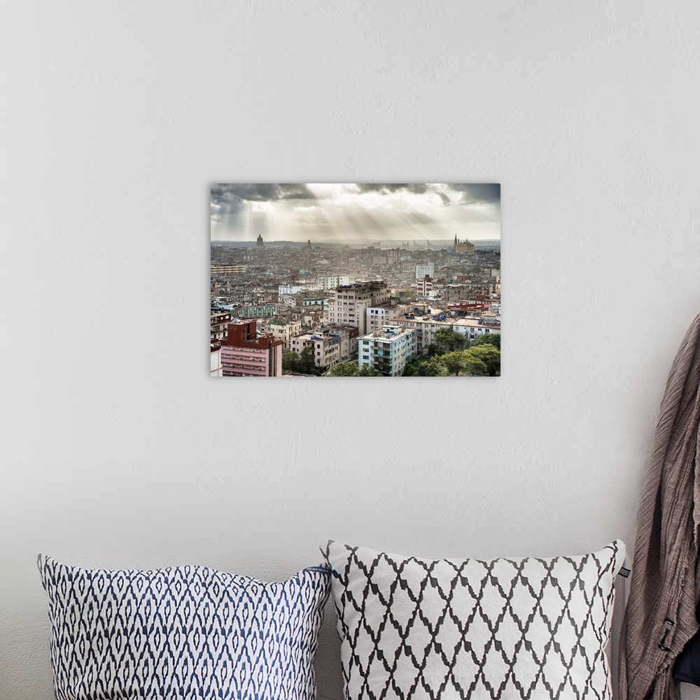 A bohemian room featuring Beautiful photograph of the sun beaming through the clouds over the city of Havana.