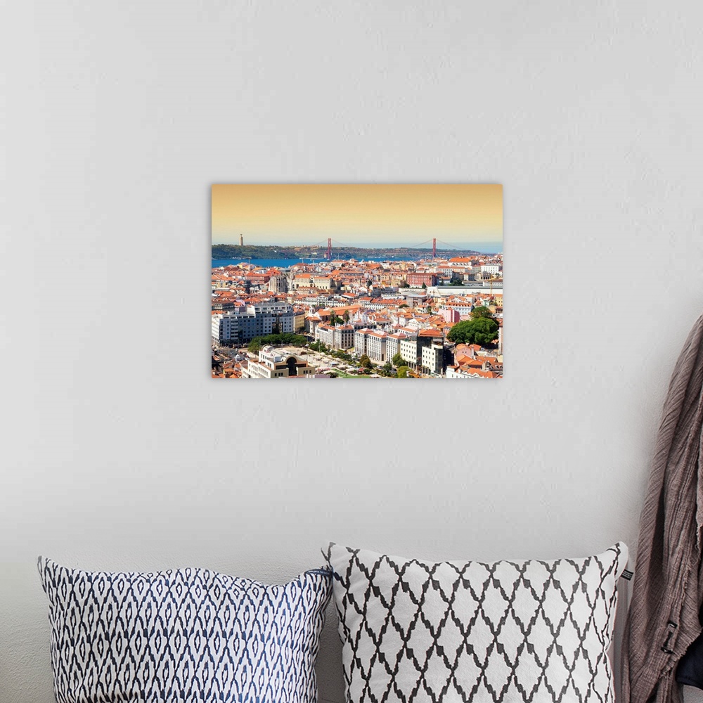 A bohemian room featuring It's a view of the city of Lisbon at sunset with the 25 de Abril bridge in Portugal.