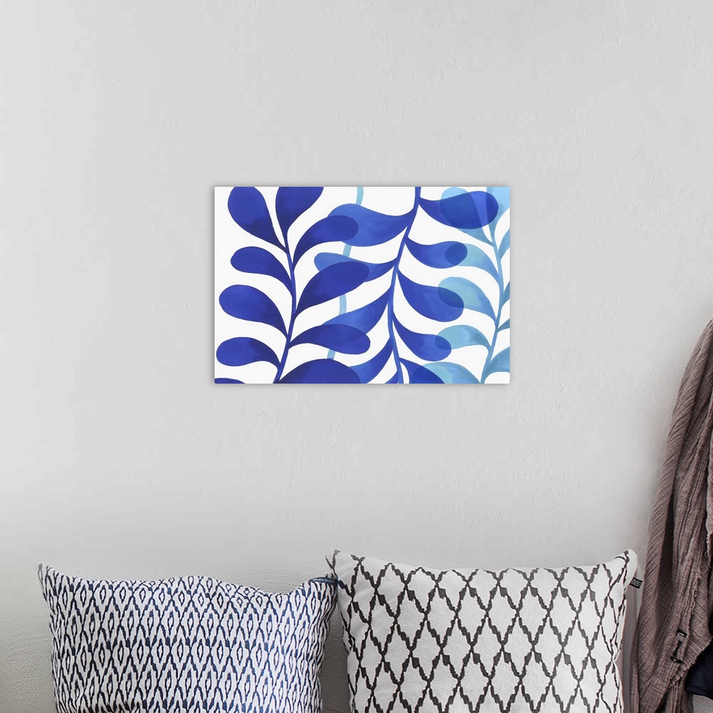 A bohemian room featuring A modern painting of three branches of leaves in different shades of blue on a white backdrop.