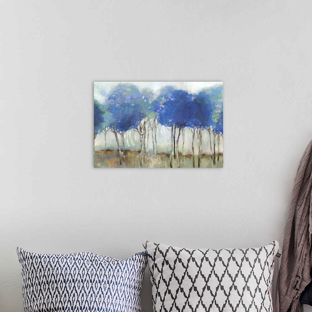 A bohemian room featuring Abstract painting of a forest of brilliant blue trees.