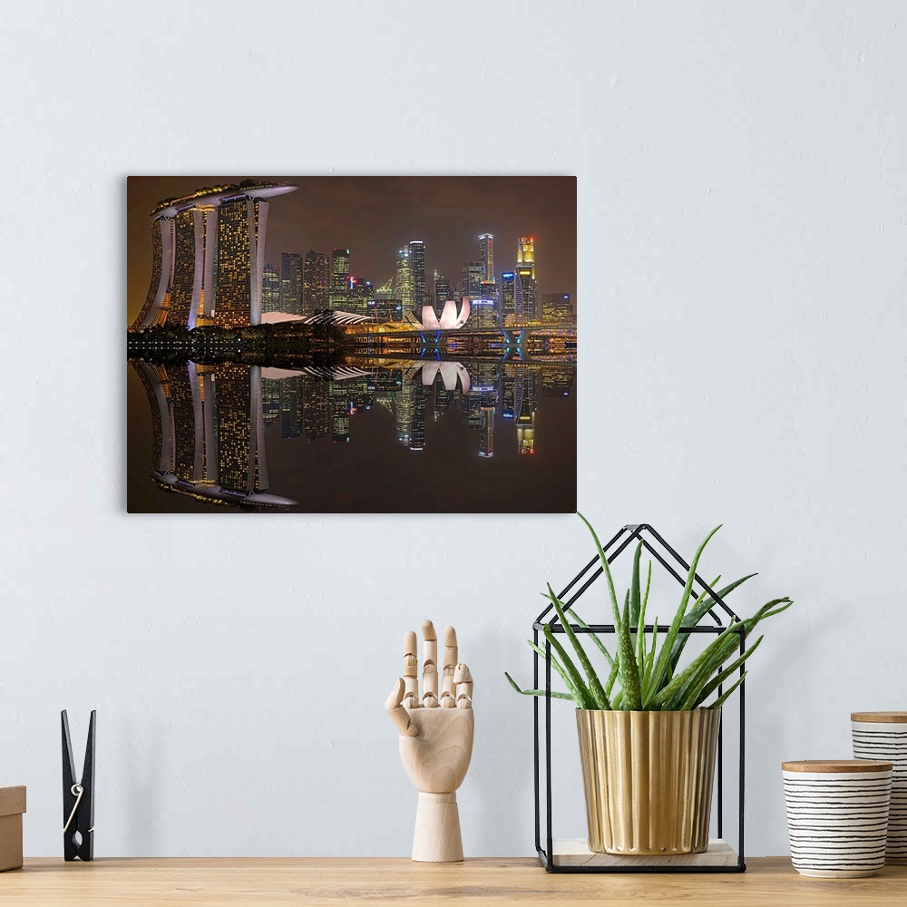 A bohemian room featuring Skyscrapers in the city of Singapore at night, reflected in the waters of the marina.
