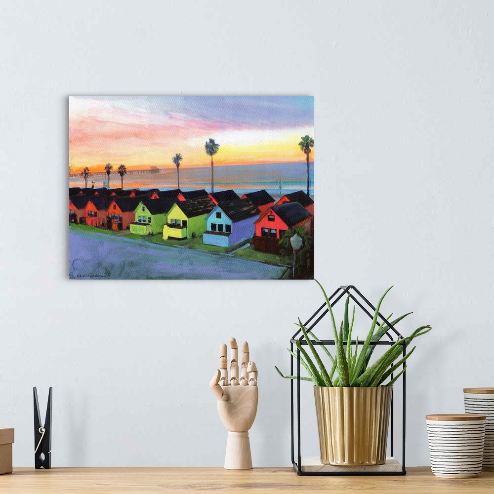 A bohemian room featuring Painting of the sunrise over Oceanside California with Roberts multicolored Cottages and Oceansid...