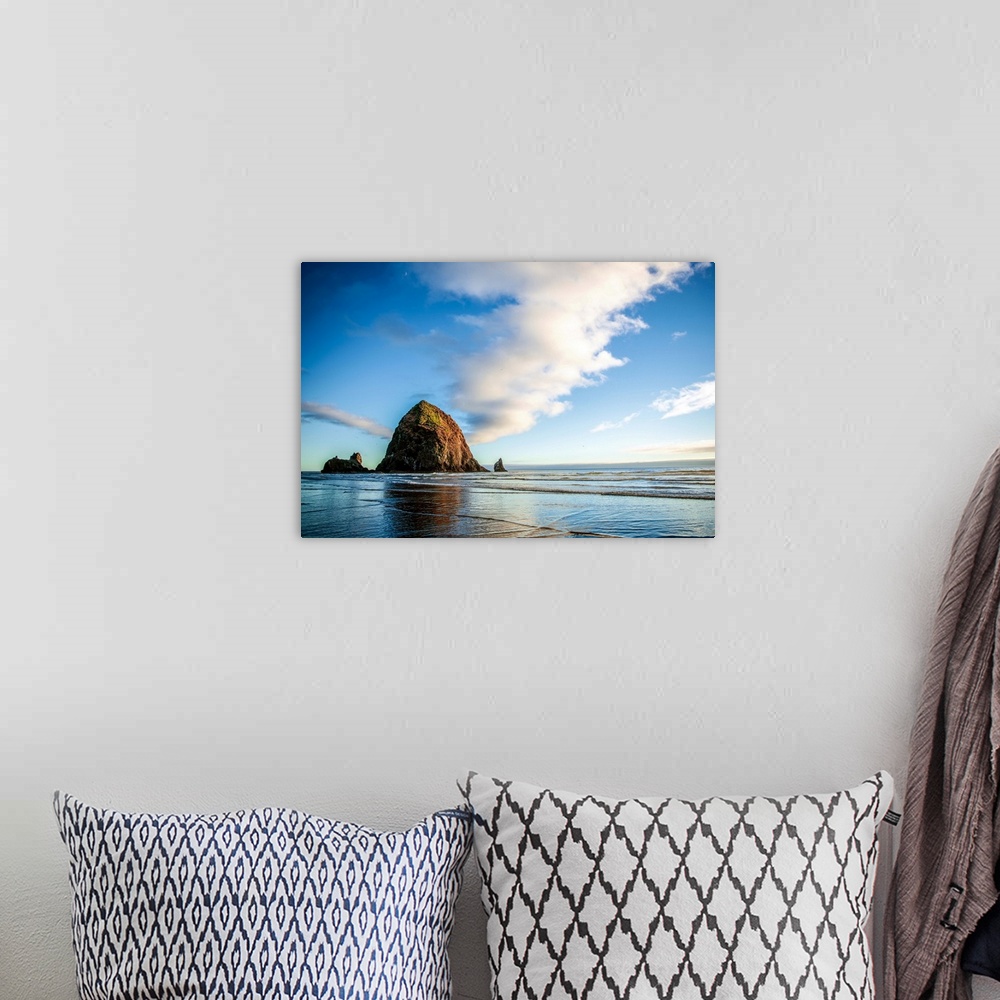 A bohemian room featuring Photograph of Haystack Rock at golden hour just before sunset.