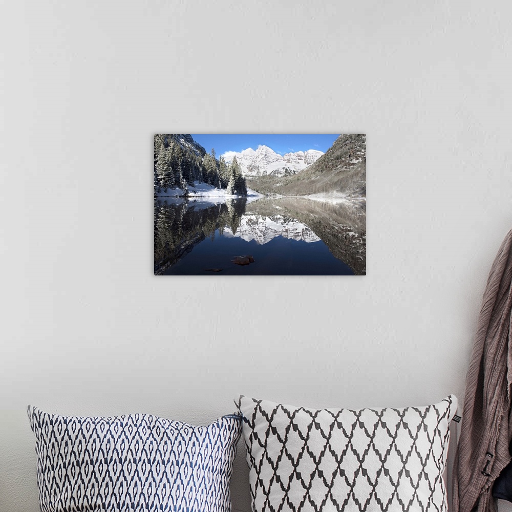A bohemian room featuring Snowy peaks of the Maroon Bells mirrored perfectly in the waters of the Maroon Lake below, Aspen,...