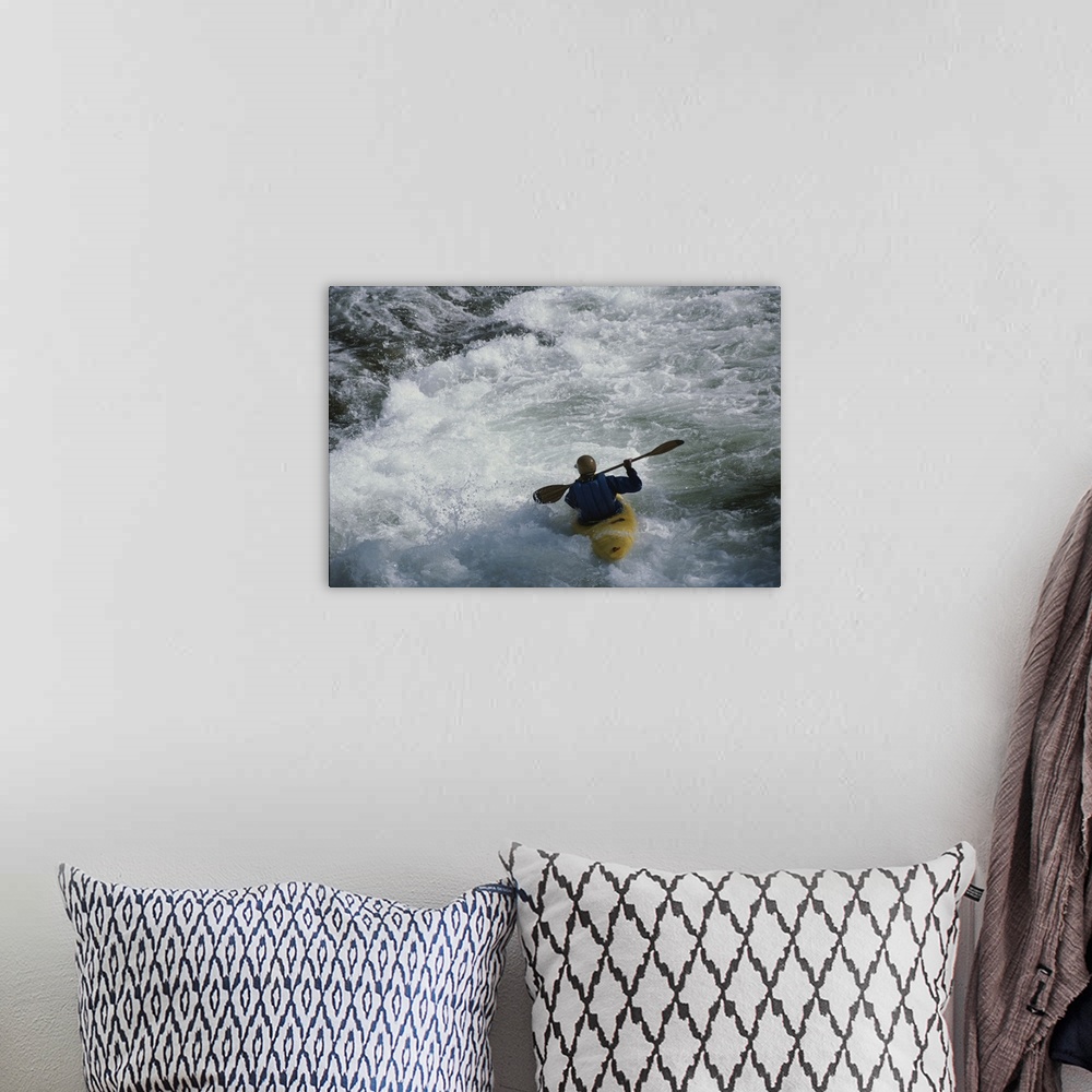 A bohemian room featuring A kayaker paddles through white-water rapids on the Snake River.