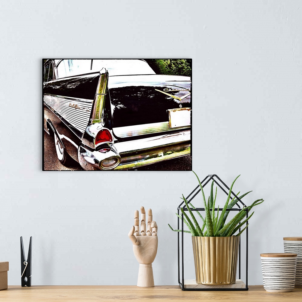 A bohemian room featuring Photograph of the back side of a vintage black Chevrolet Bel-Air.