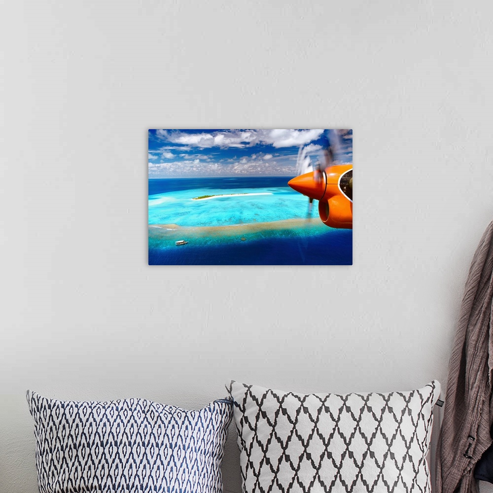 A bohemian room featuring Aerial view of island and seaplane, Male Atoll, The Maldives, Indian Ocean, Asia