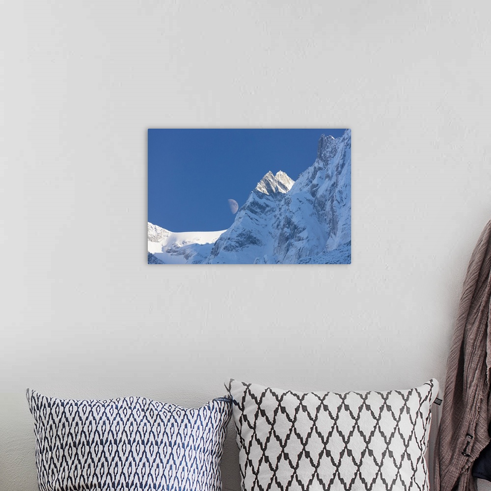 A bohemian room featuring Blue sky and moon on the snowy ridges of the high peaks, Soglio, Bregaglia Valley, Canton of Grau...
