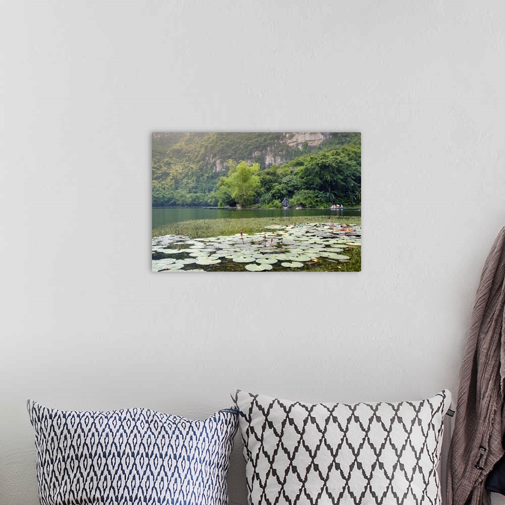 A bohemian room featuring Boats and waterlilies on a river in the karst landscapes of Tam Coc and Trang An in the Red River...
