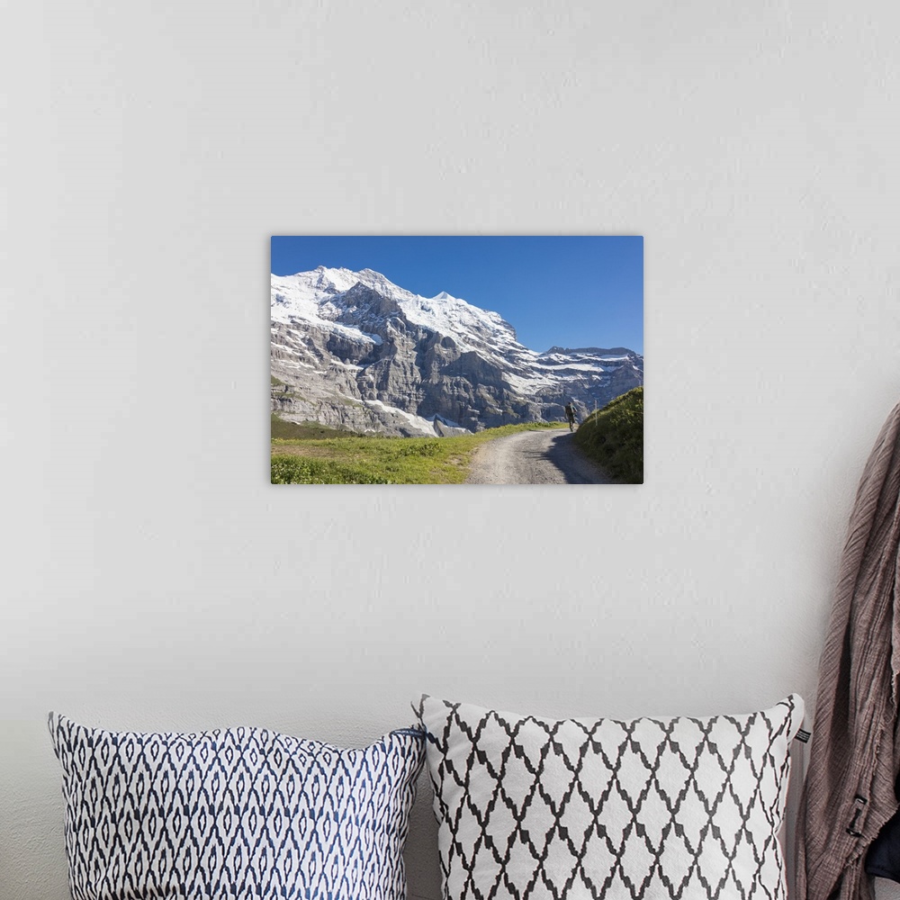 A bohemian room featuring Hiker on the path between green meadows and snowy peaks, Wengernalp, Wengen, Bernese Oberland, Ca...