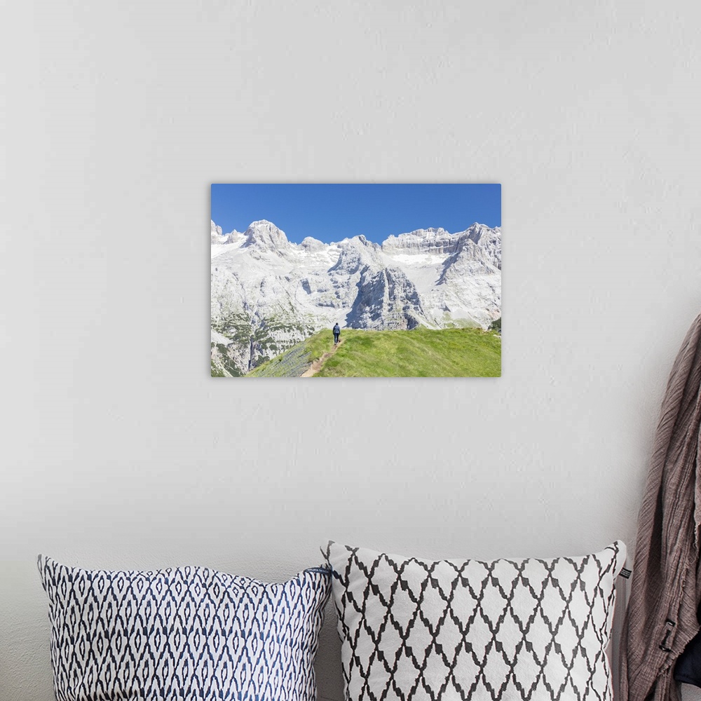 A bohemian room featuring Hiker proceeds on the path to the rocky peaks, Doss Del Sabion, Pinzolo, Brenta Dolomites, Trenti...