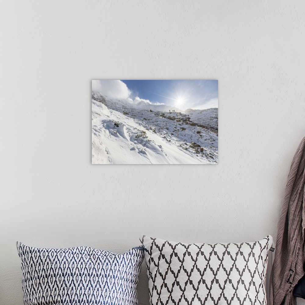 A bohemian room featuring Hikers proceed in the snowy valley of Alpe Fora, Malenco Valley, Province of Sondrio, Valtellina,...