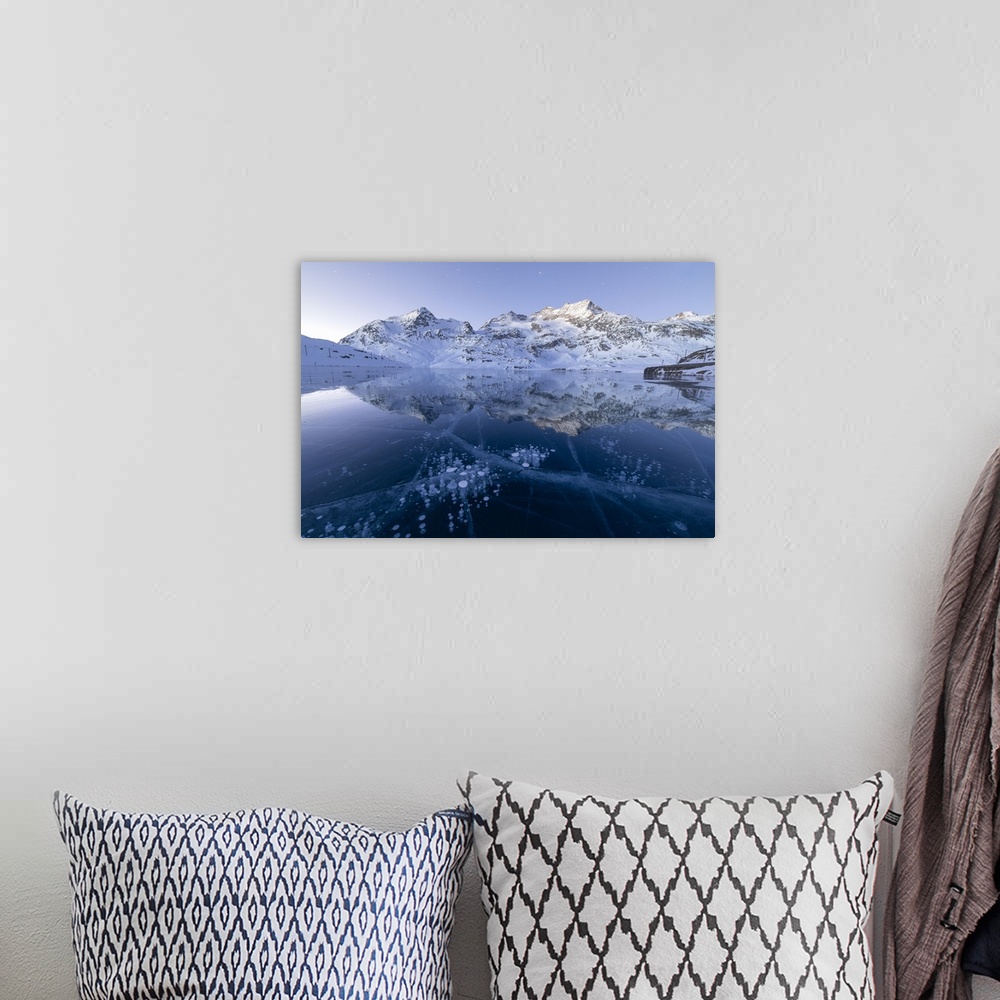 A bohemian room featuring Ice bubbles frame the snowy peaks reflected in Lago Bianco, Bernina Pass, canton of Graubunden, E...