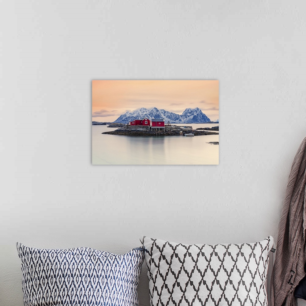 A bohemian room featuring Isolated red fishermen's cabins on rocks in the cold sea at sunset, Svolvaer, Nordland county, Lo...