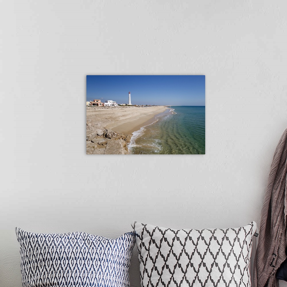 A bohemian room featuring Lighthouse and beach of Ilha do Farol, Culatra barrier island, Olhao, Algarve, Portugal