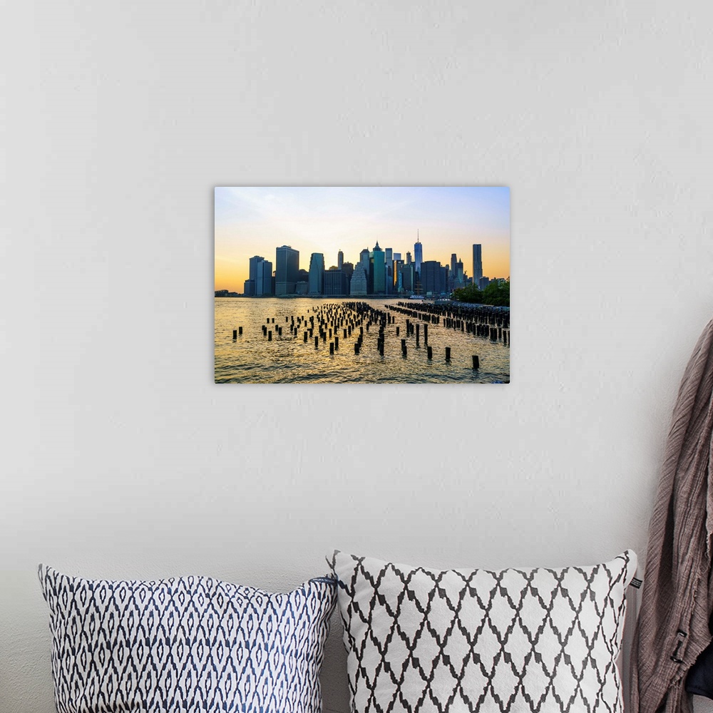 A bohemian room featuring Lower Manhattan skyline across the East River at sunset, New York City, New York, United States o...
