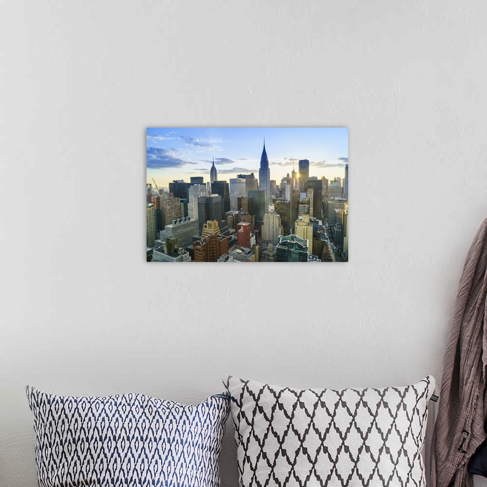 A bohemian room featuring Manhattan skyline, Empire State Building and Chrysler Building at sunset, New York City, United S...