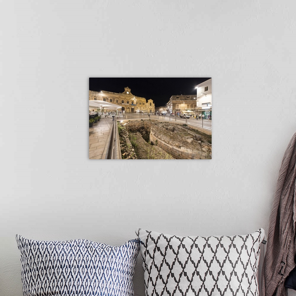 A bohemian room featuring Night view of the Town Hall and ancient ruins in the medieval old town of Ostuni, Province of Bri...