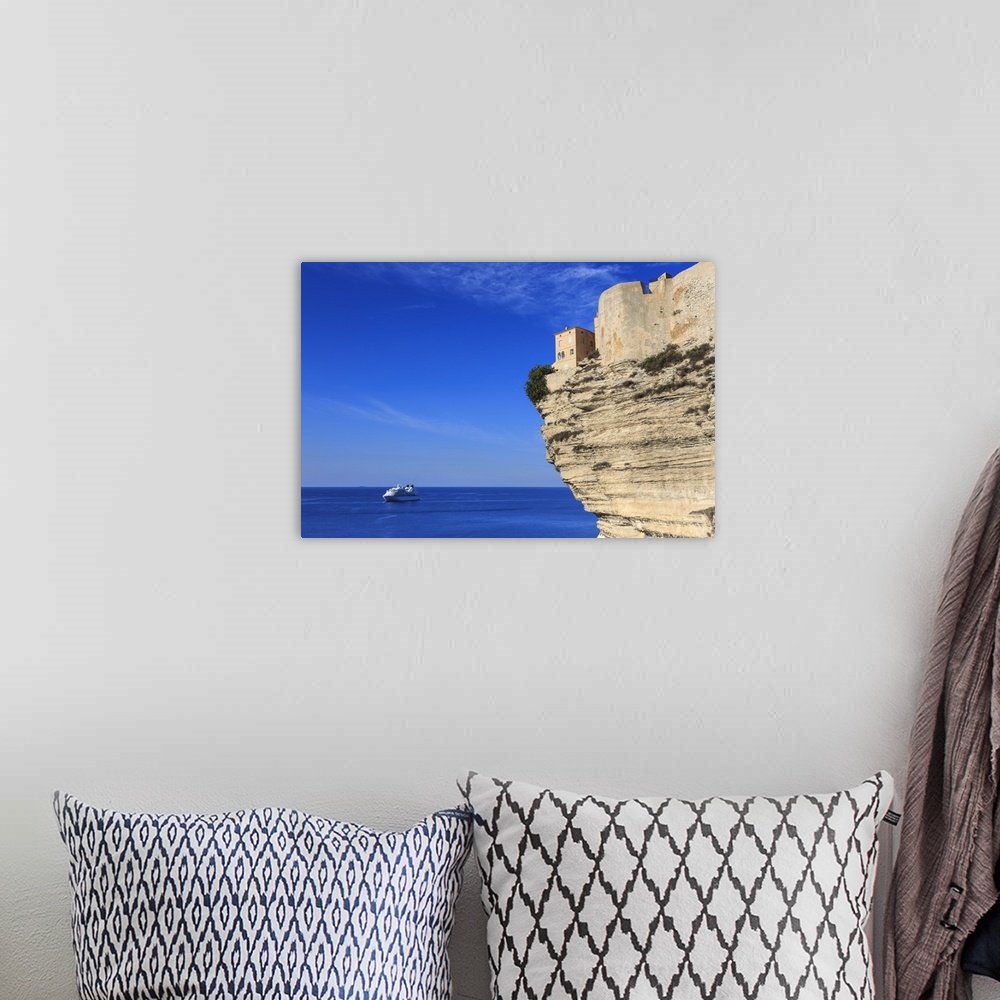 A bohemian room featuring Old citadel atop cliffs with cruise ship anchored off shore, Bonifacio, Corsica, France, Mediterr...