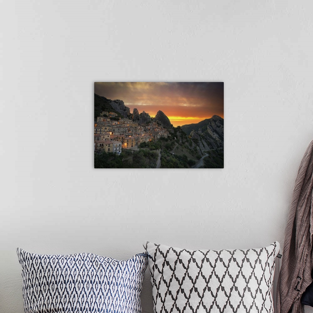 A bohemian room featuring Burning sky at sunrise over the old houses of Castelmezzano and Dolomiti Lucane mountains, Potenz...