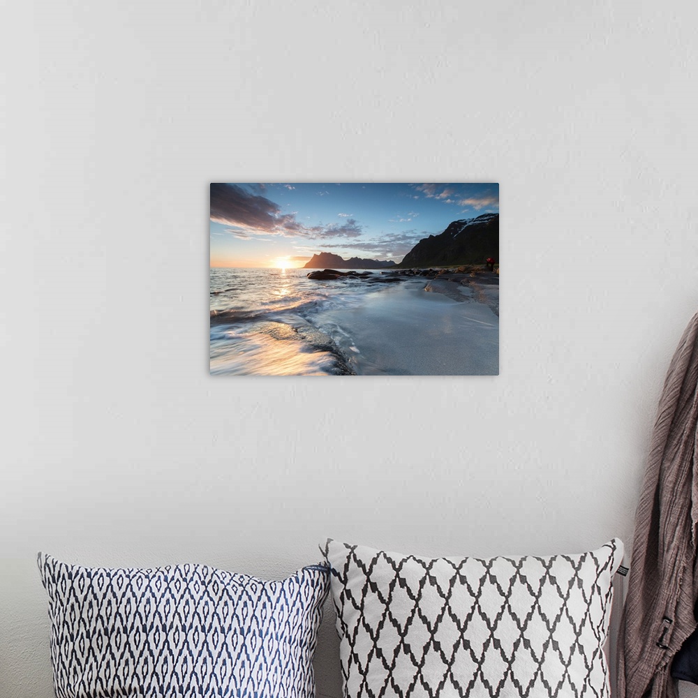 A bohemian room featuring Pink clouds and midnight sun reflected on the waves of blue sea framed by rocky peaks, Uttakleiv,...