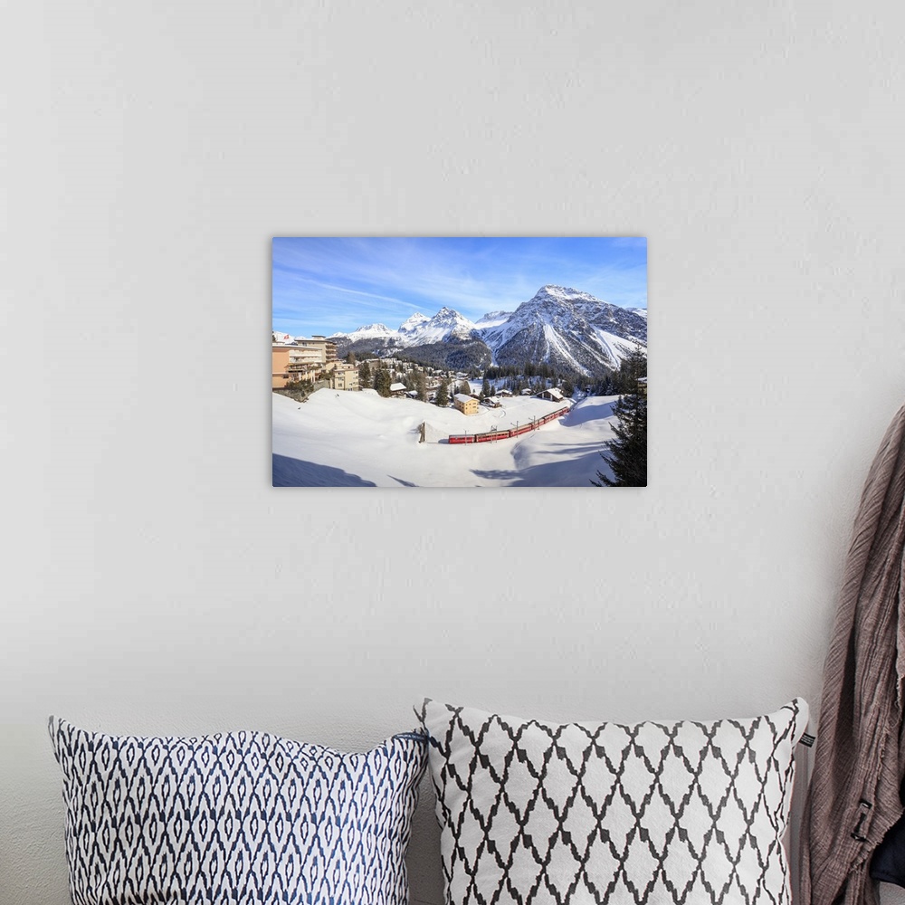 A bohemian room featuring Red train of Rhaetian Railway passes in the snowy landscape of Arosa, district of Plessur, Canton...