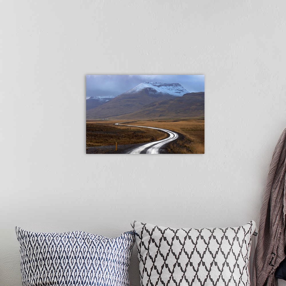 A bohemian room featuring Road and landscape in Vatsnes Peninsula, with snow-covered mountains in October, north coast of I...