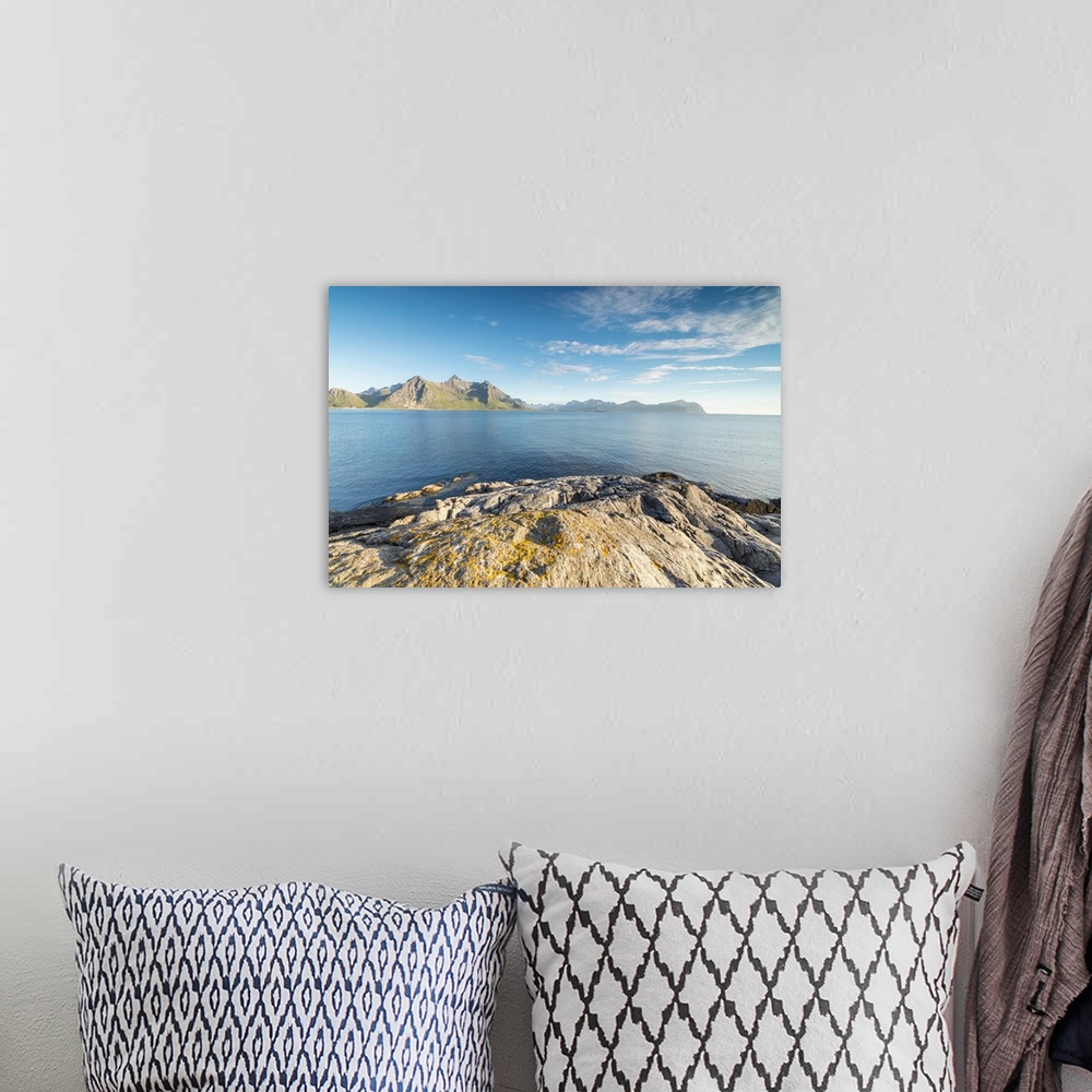 A bohemian room featuring Sun shines on the blue sea and the rocky peaks at night during summer, Vikten, Nord Trondelag, Lo...