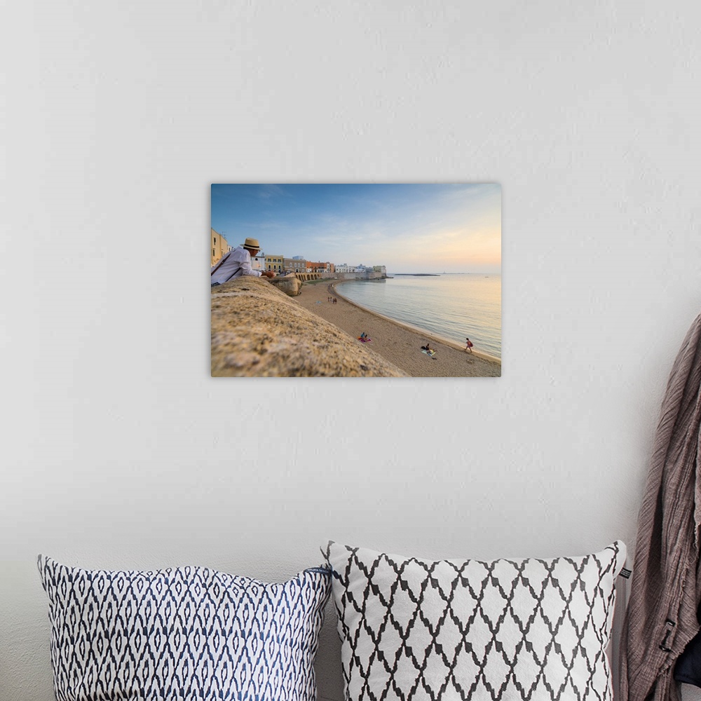A bohemian room featuring Sunset frames the beach and the turquoise sea, Gallipoli, Province of Lecce, Apulia, Italy