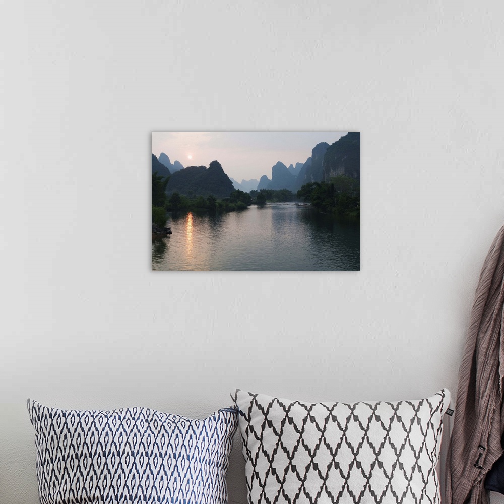 A bohemian room featuring Sunset over karst limestone scenery on the Li river in Yangshuo, China