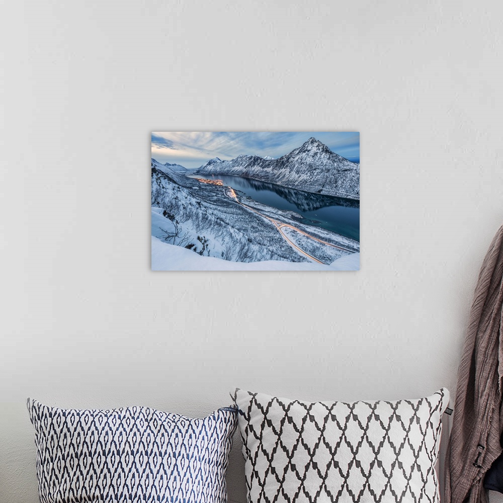 A bohemian room featuring The snowy peaks above the frozen sea framed by the blue lights of dusk, Gryllefjorden, Senja, Tro...