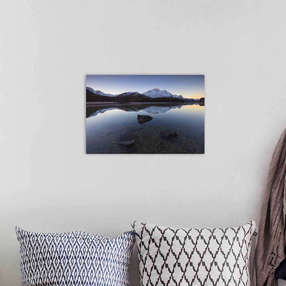 A bohemian room featuring The snowy peaks are reflected in Lake Champfer at sunrise, St. Moritz, Canton of Graubunden, Enga...