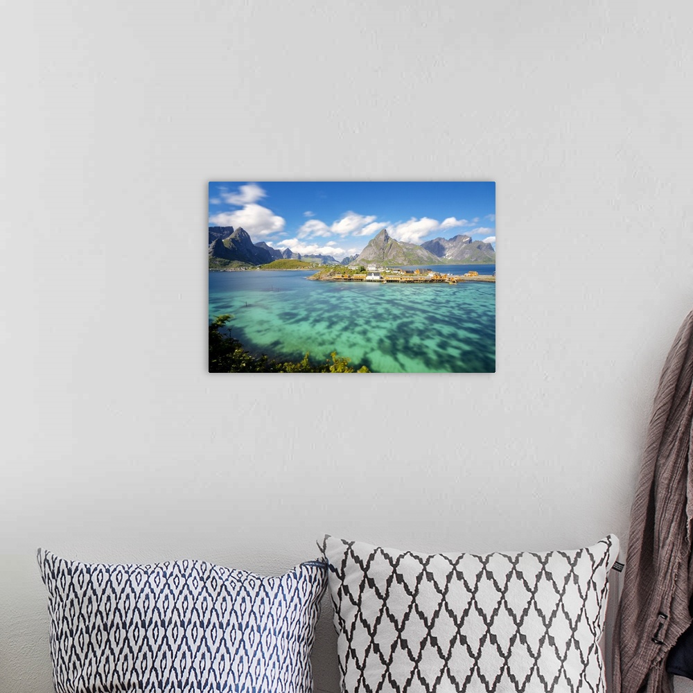 A bohemian room featuring The turquoise sea frames the typical fishing village surrounded by rocky peaks, Sakrisoy, Reine, ...