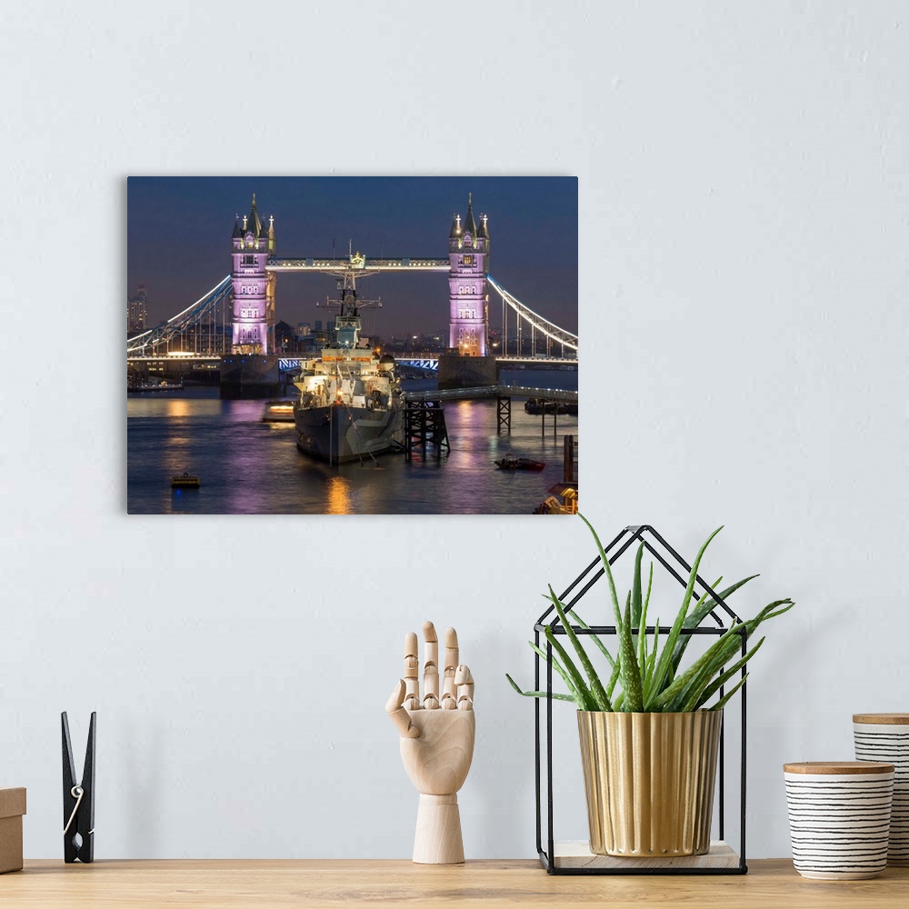 A bohemian room featuring Tower Bridge and HMS Belfast on the River Thames at dusk, London, England