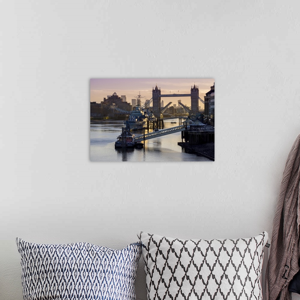 A bohemian room featuring Tower Bridge raising deck with HMS Belfast on the River Thames, London, England