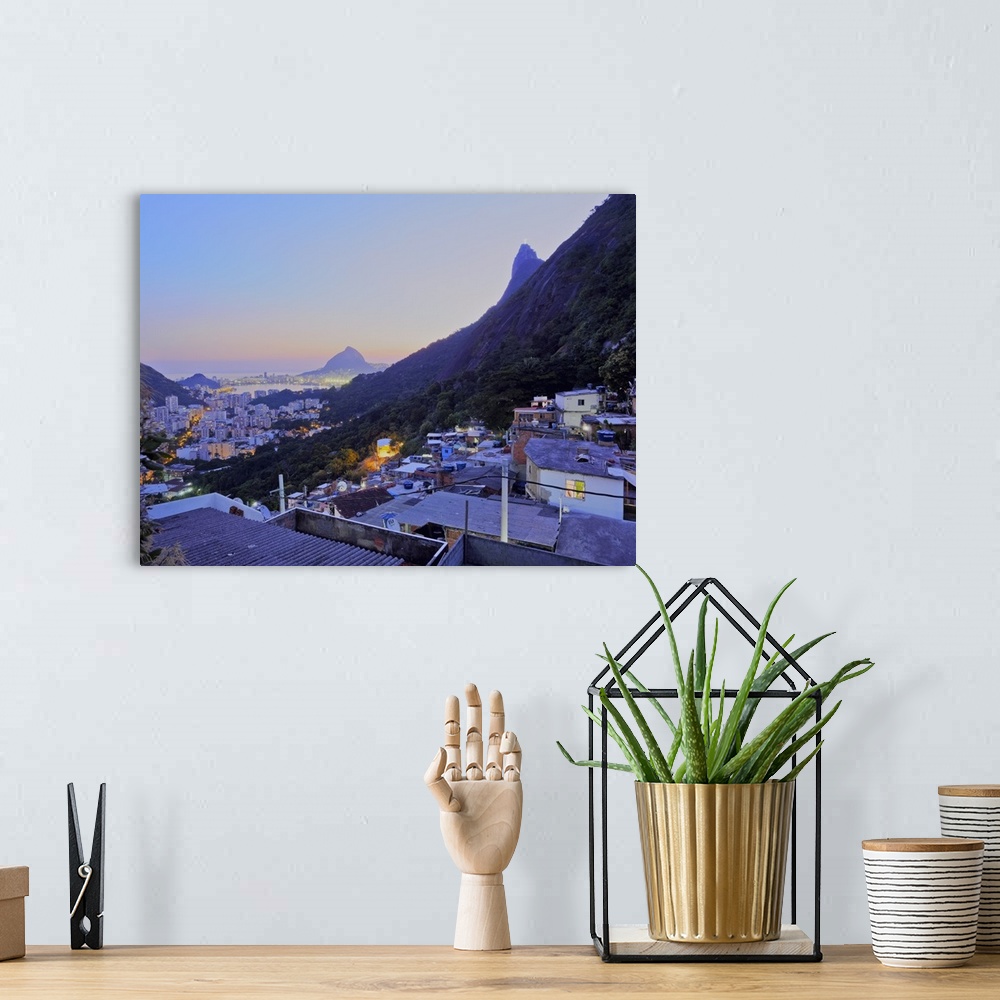 A bohemian room featuring Twilight view of the Favela Santa Marta with Corcovado and the Christ statue behind, Rio de Janei...