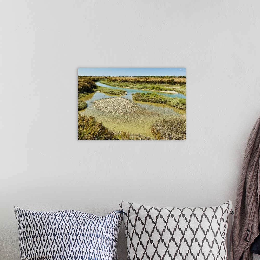 A bohemian room featuring Waterways and cracked mud in the salt marshes of the island's west, near Le Griveau, Ars en Re, I...