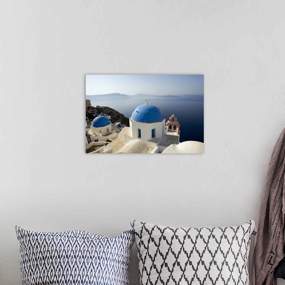 A bohemian room featuring Photograph taken on the coast of Greece looking out toward the water with blue domed churches sit...