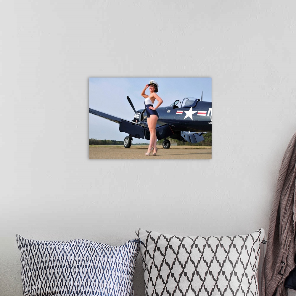 A bohemian room featuring Beautiful 1940's style Navy pin-up girl posing with a vintage Corsair aircraft.
