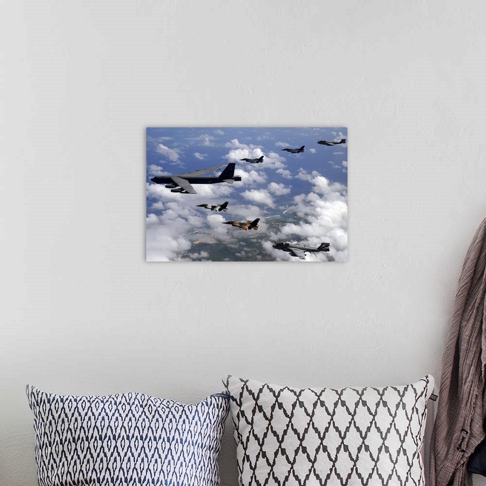 A bohemian room featuring Military aircrafts are photographed flying high and in formation over Guam.