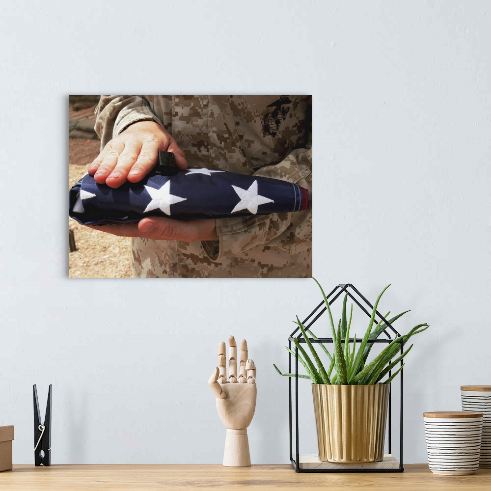 A bohemian room featuring A soldier holds the United States flag.