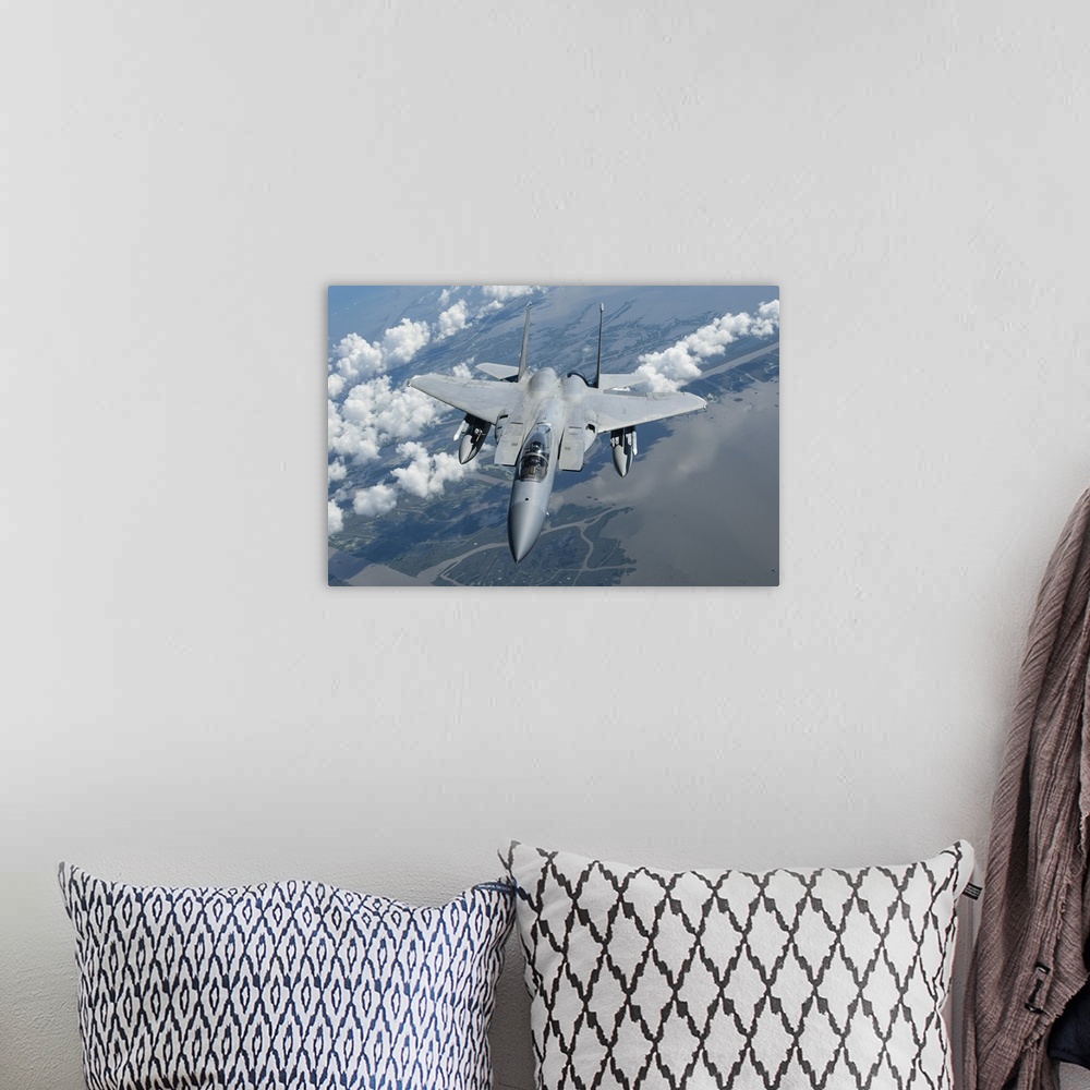 A bohemian room featuring A U.S. Air Force F-15C over the Gulf of Mexico.