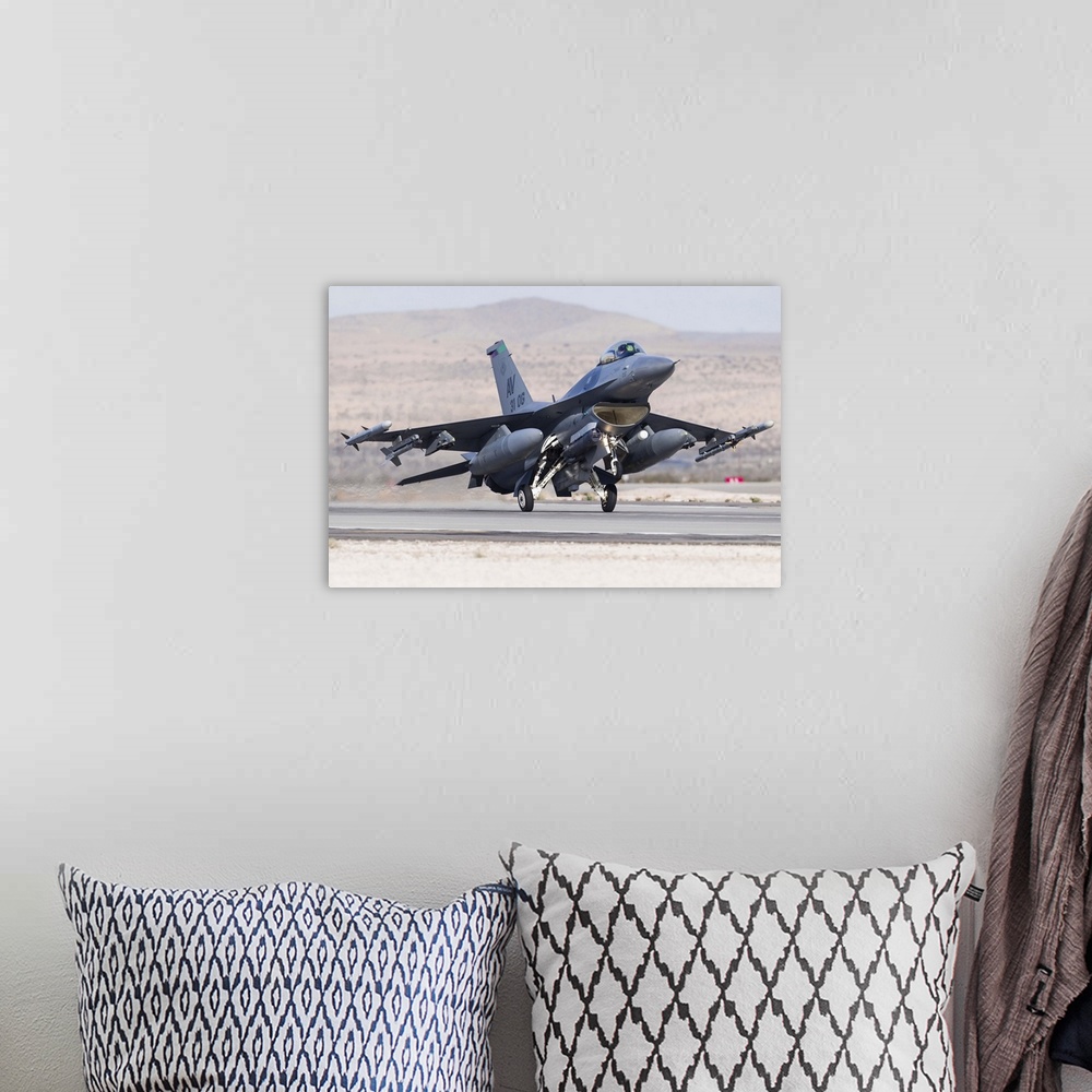 A bohemian room featuring A U.S. Air Force F-16C Fighting Falcon landing at Nellis Air Force Base, Nevada.