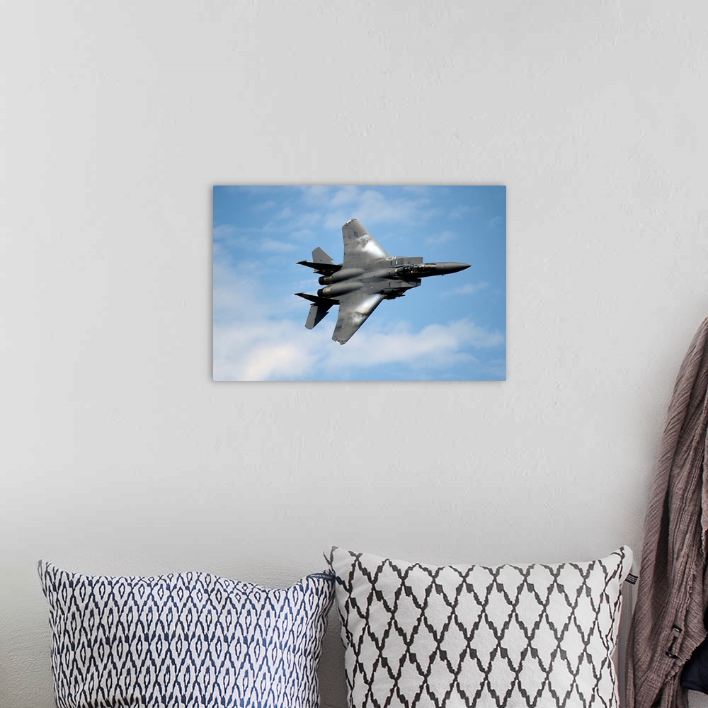 A bohemian room featuring An F-15E Strike Eagle soars through the sky.
