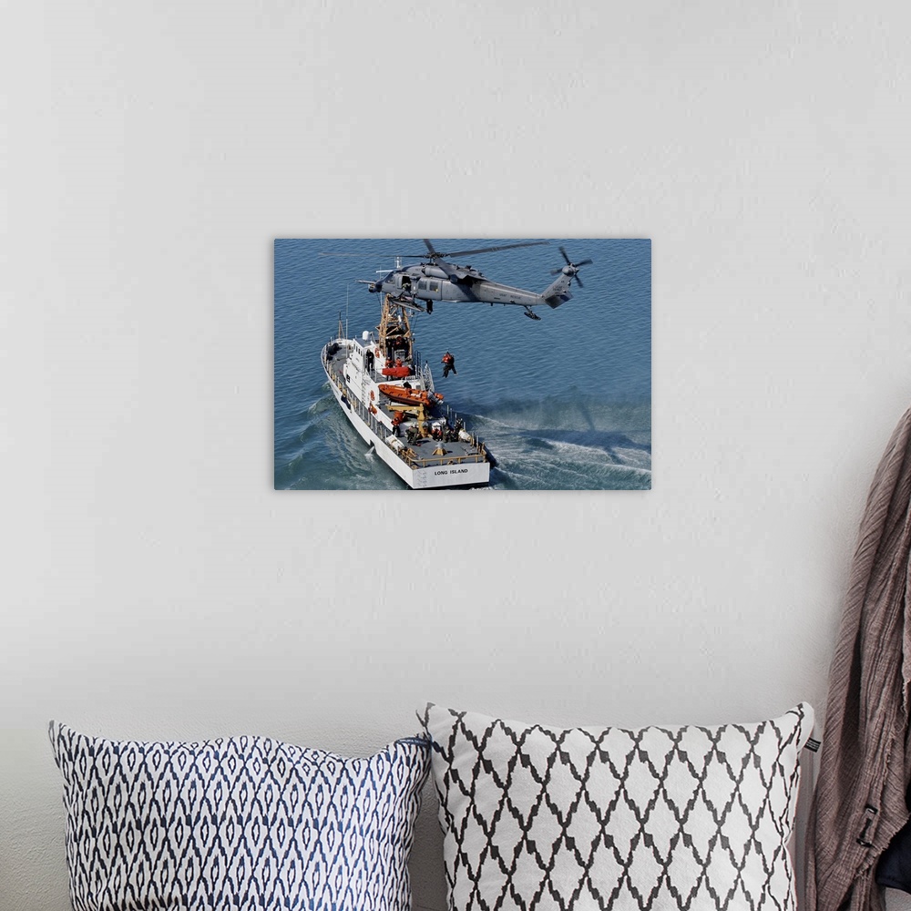 A bohemian room featuring An HH-60G Pave Hawk performs a hoist over U.S. Coast Guard Cutter Long Island.