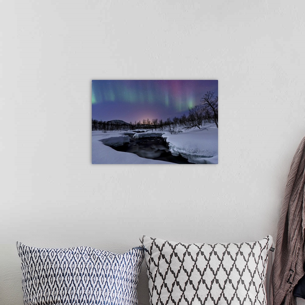 A bohemian room featuring Aurora Borealis over Blafjellelva RIver in Troms County, Norway. Auroras are the result of the em...