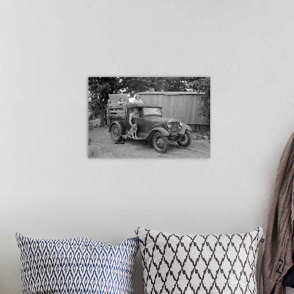 A bohemian room featuring Great Depression era photograph of a migrant family in a packed car preparing to leave.