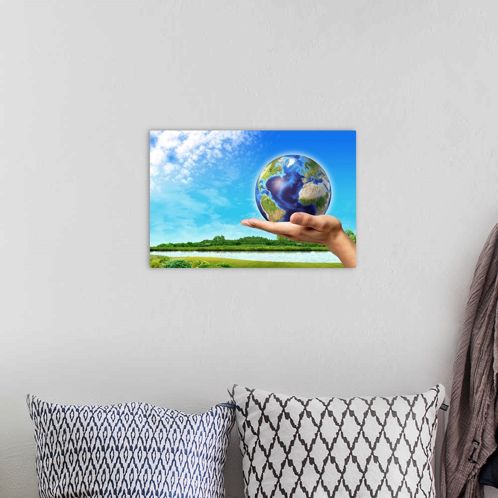 A bohemian room featuring Human hand holding Earth globe with a green landscape background.
